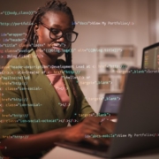 Image of woman working on computer with code overlaid on top of image