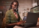 Image of woman working on computer with code overlaid on top of image