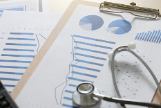 Image of Stethoscope on top of financial papers