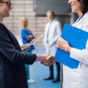 Image of business person and doctor shaking hands