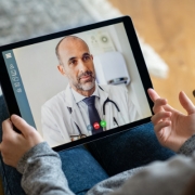 Image of tablet as doctor talks on a telehealth appointment