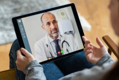 Image of tablet as doctor talks on a telehealth appointment