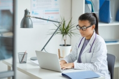 Image of a doctor working at a laptop